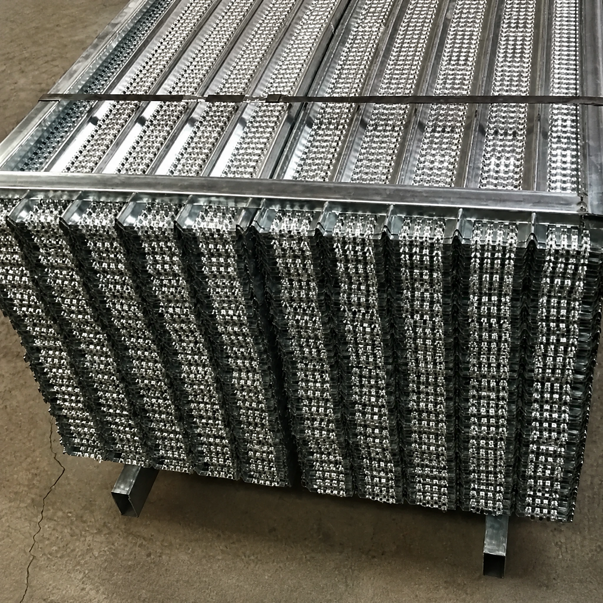 Galvanized high rib lath for concrete forming and plaster